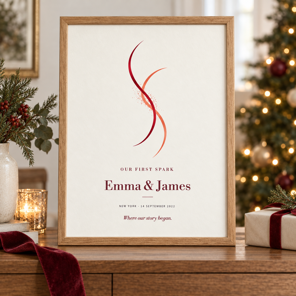 Our First Spark personalized couple print in an oak frame beside glowing Christmas tree lights.