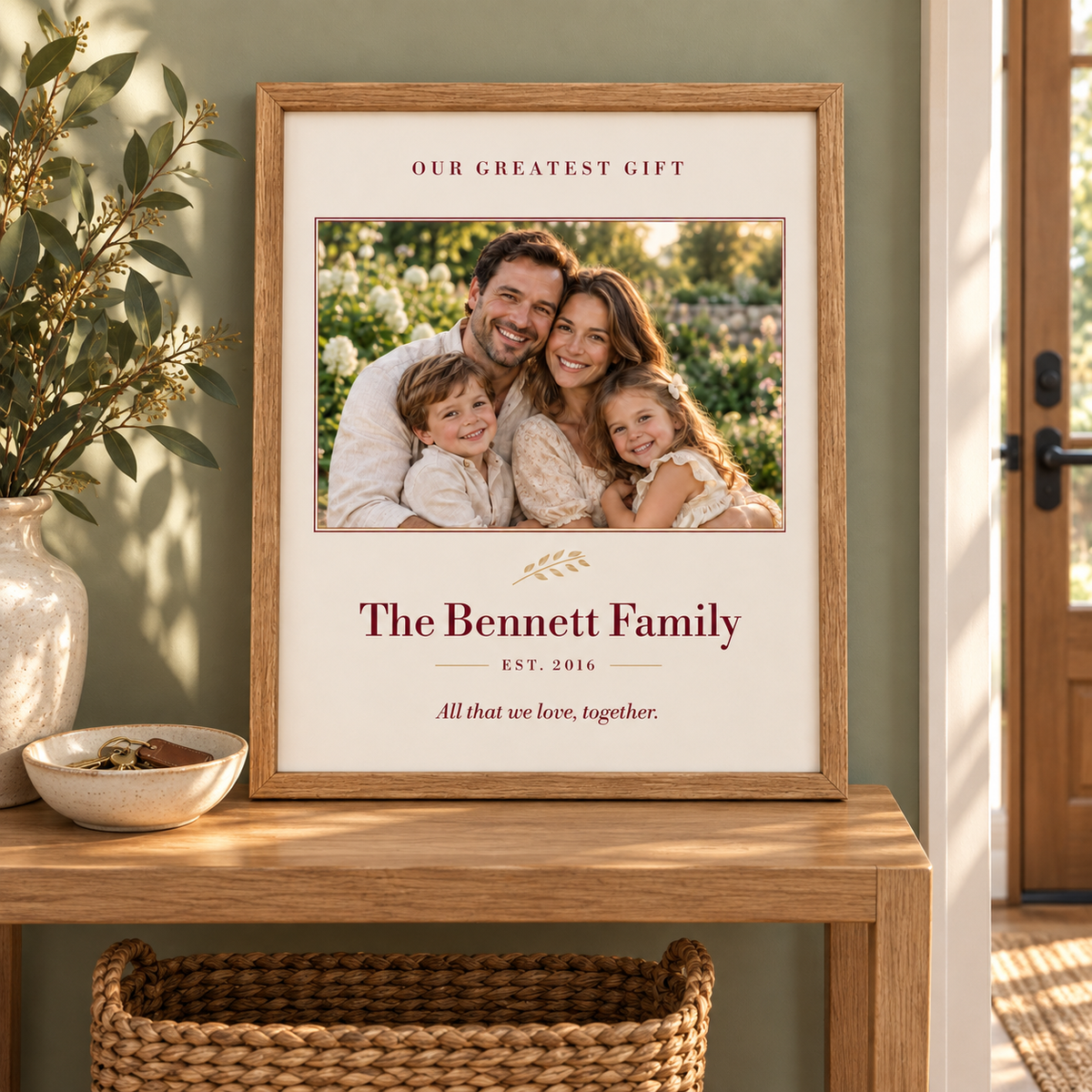 Personalized Our Greatest Gift family portrait in an oak frame on an entryway console.